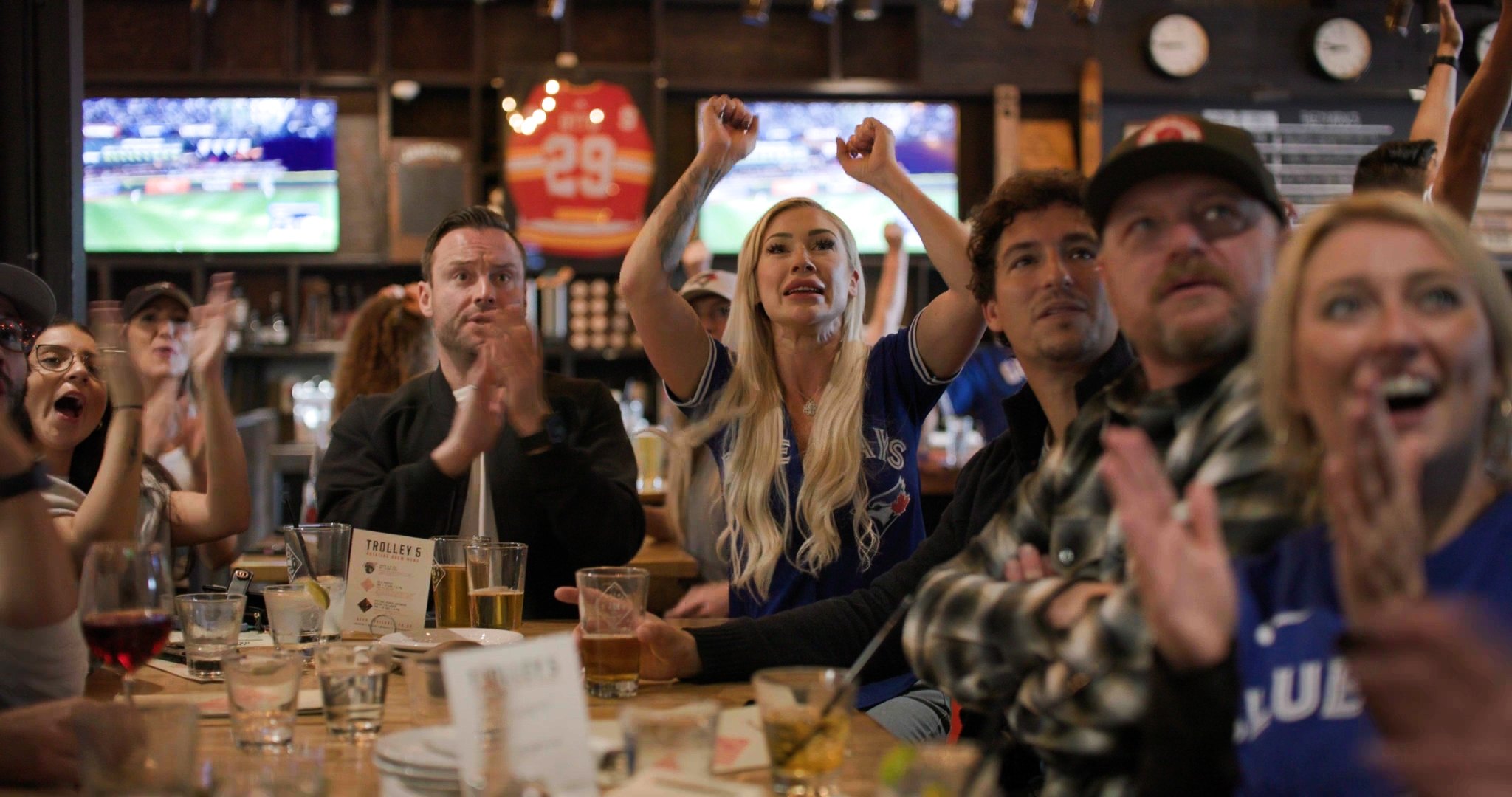 Fans reacting at a Calgary bar during the Blue Jays game — frame from the Westside Studio World Series campaign