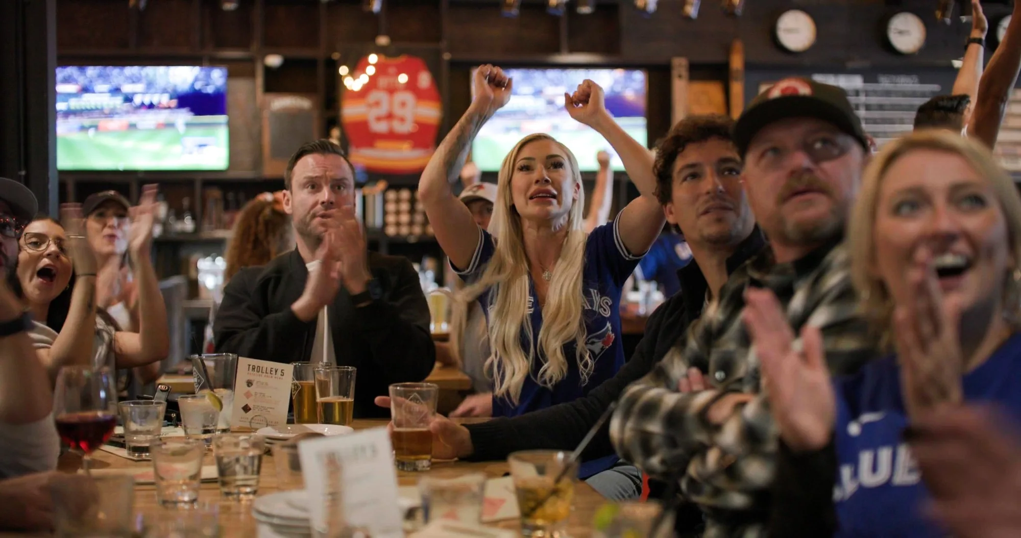 Fans reacting at a Calgary bar during the Blue Jays game — frame from the Westside Studio World Series campaign