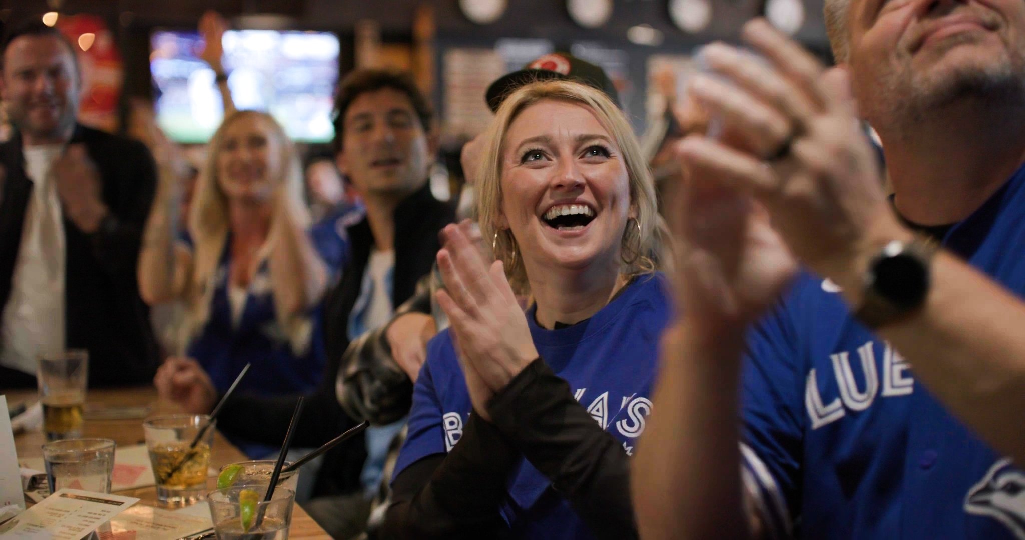 Blue Jays fans cheering at a Calgary bar — ad frame