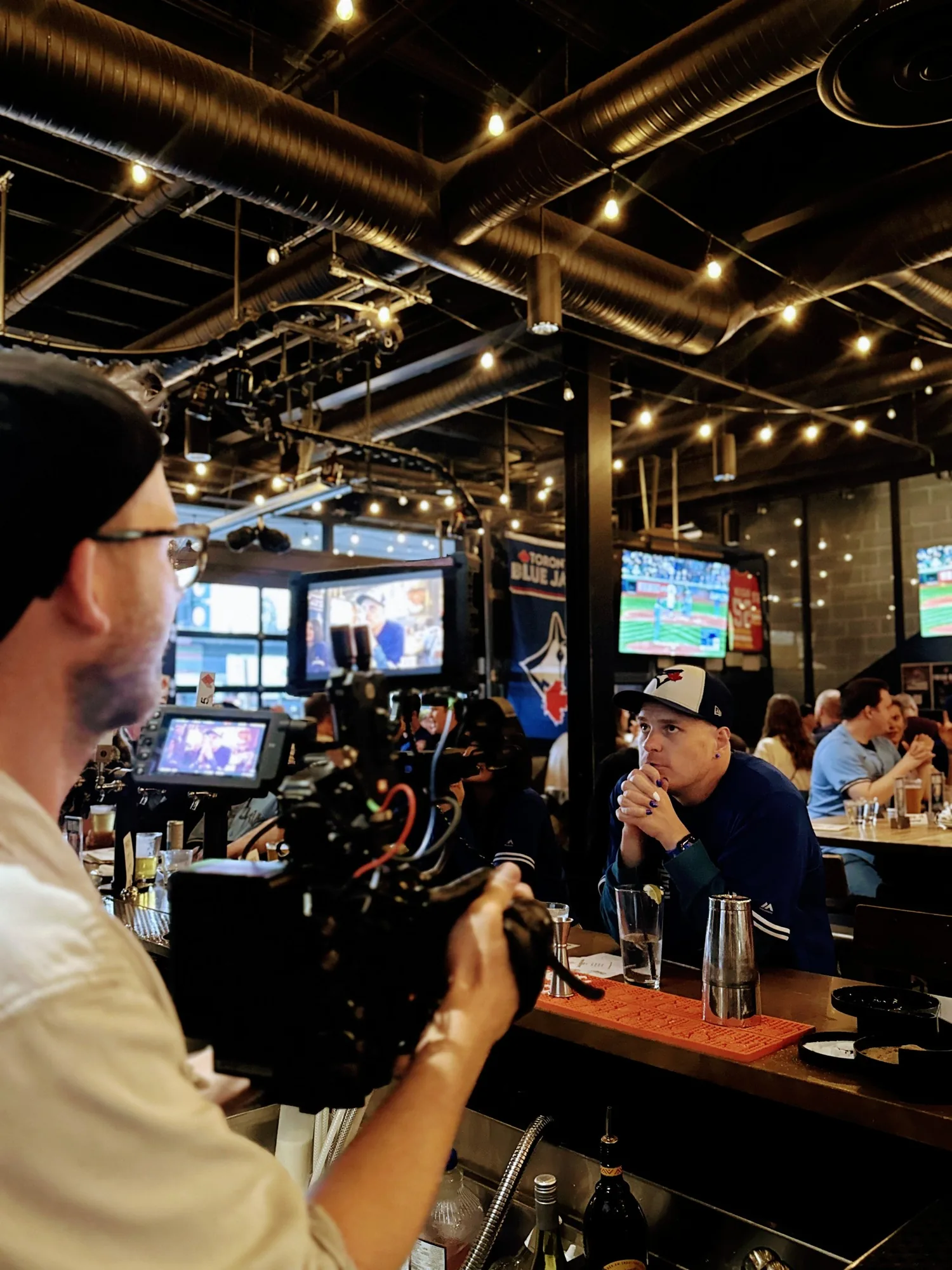 BTS: David Copithorne filming the praying-hands shot at the bar during the Blue Jays campaign