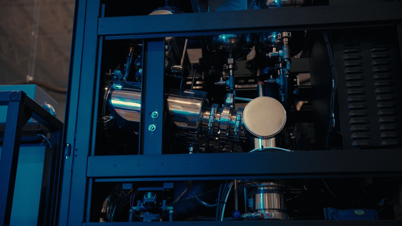 Close-up of CoolIT liquid cooling hardware lit in blue, filmed on a cinema camera in Calgary