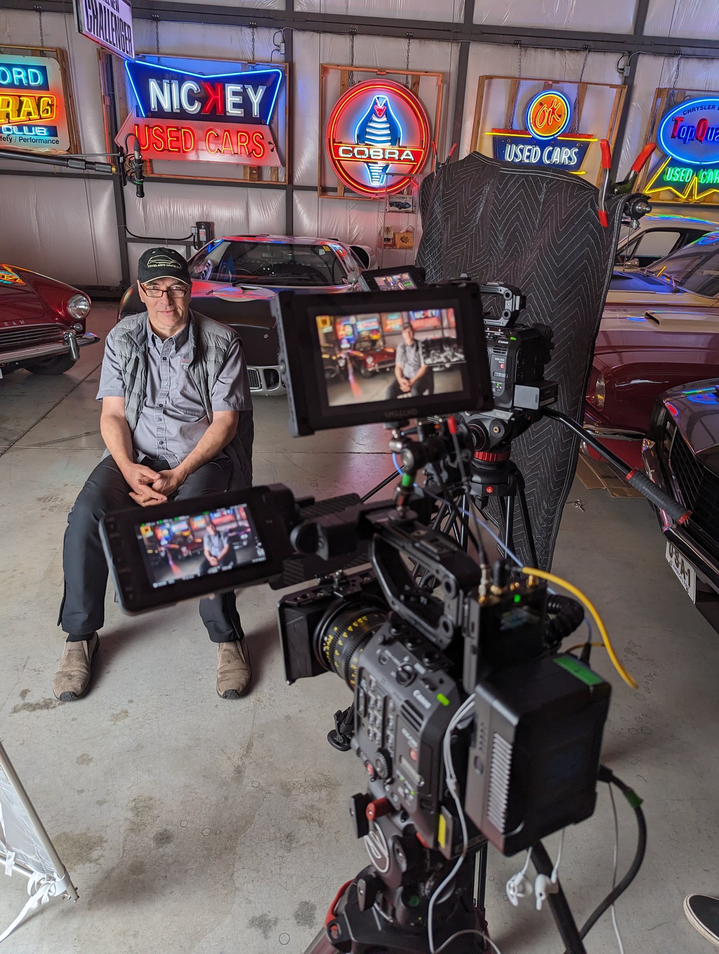 On-camera interview subject in a classic-car collection — Canon C500 documentary setup