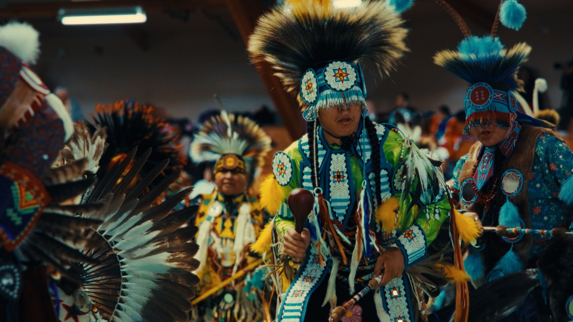 Dancers in full regalia at a powwow — Natosapi, Old Sun Community College