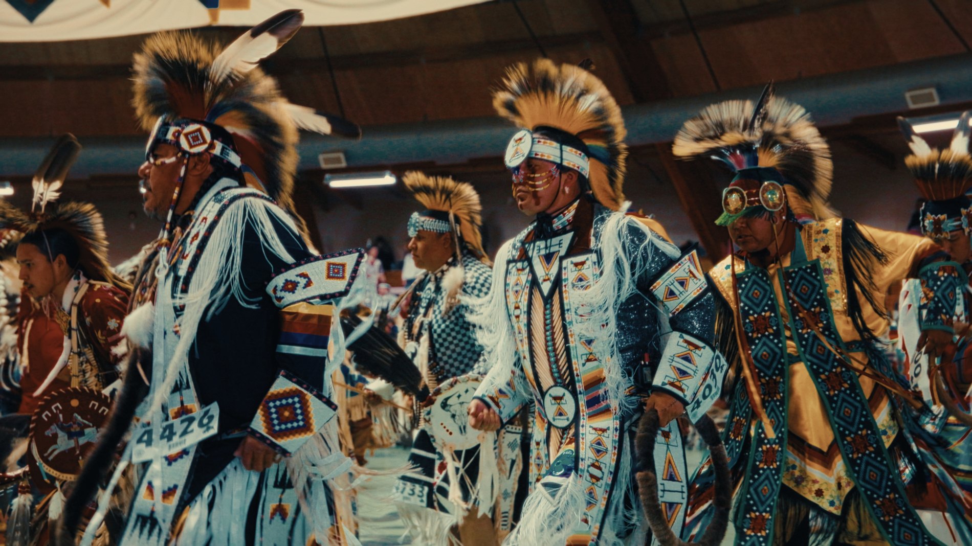 Dancers in regalia in procession at a powwow — Natosapi