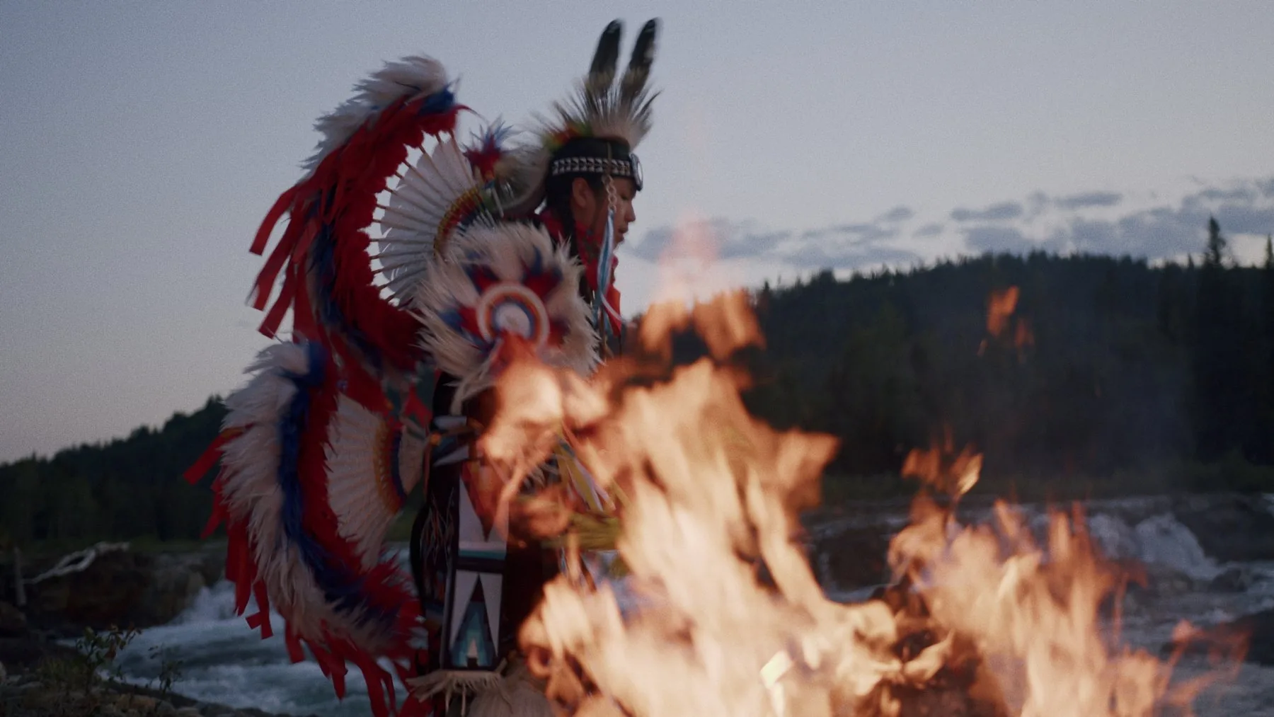 Indigenous dancer in full regalia by fire — Visit Bragg Creek