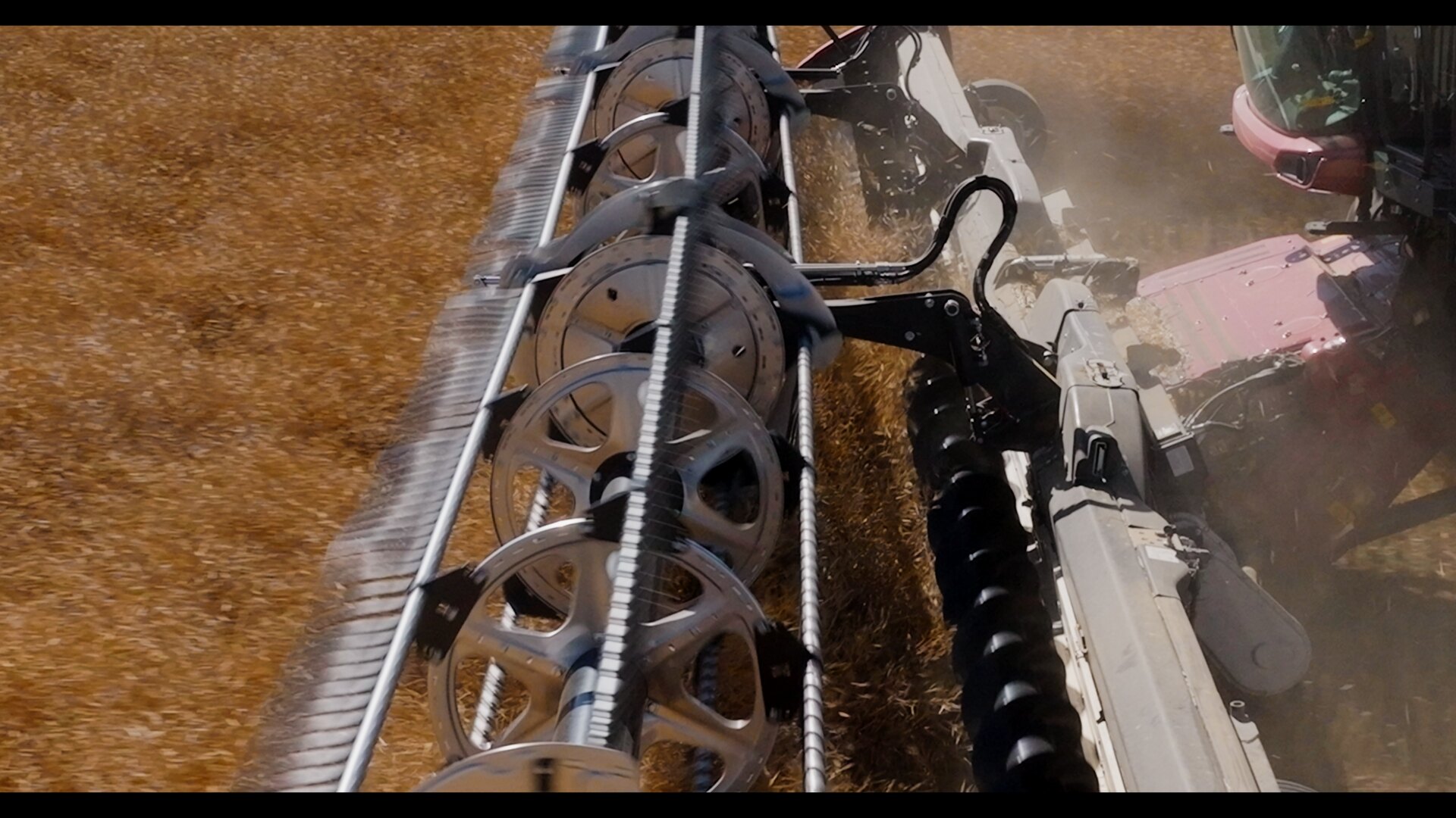 Tight aerial drone shot of a Case IH combine harvesting, Alberta