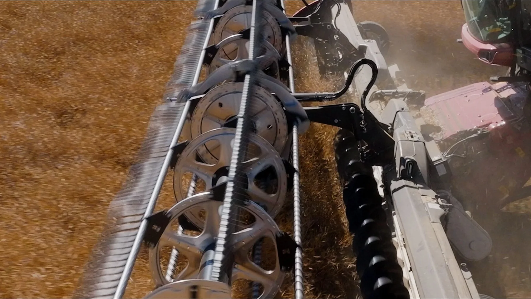 Tight aerial drone shot of a Case IH combine harvesting, Alberta