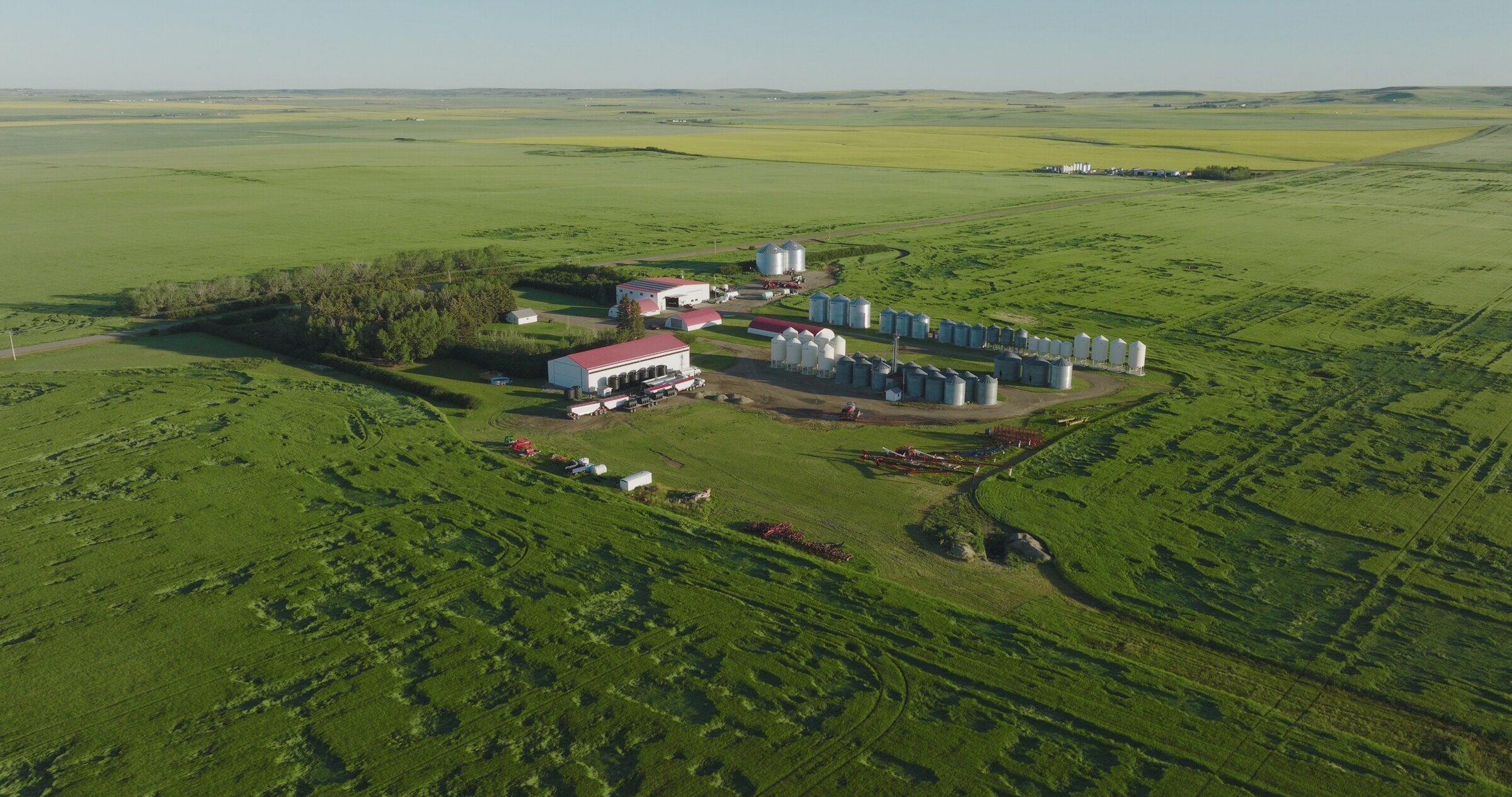 Aerial drone photo of an Alberta farm surrounded by green fields, shot for Nutrien