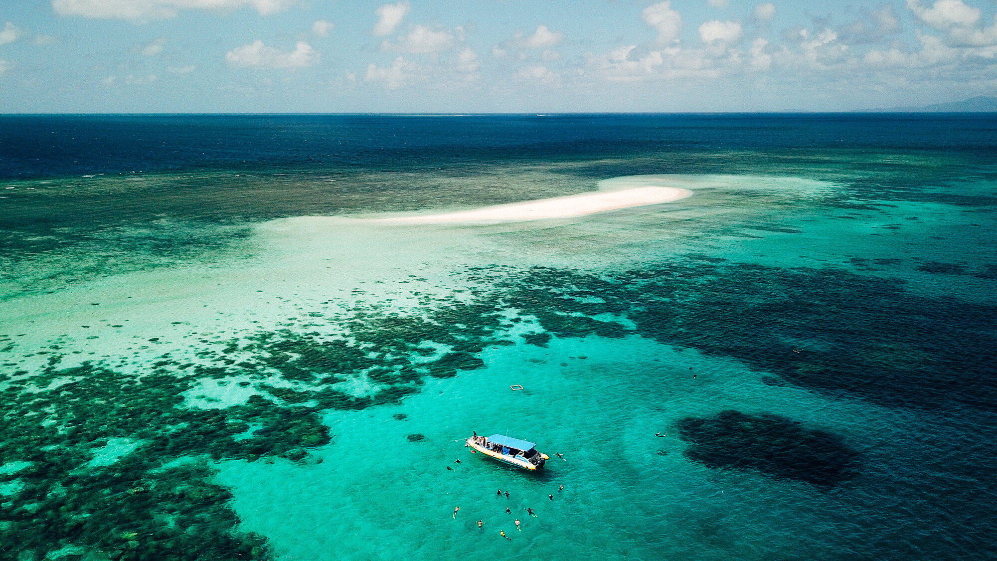 Great Barrier Reef sand cay and boat, aerial drone photo