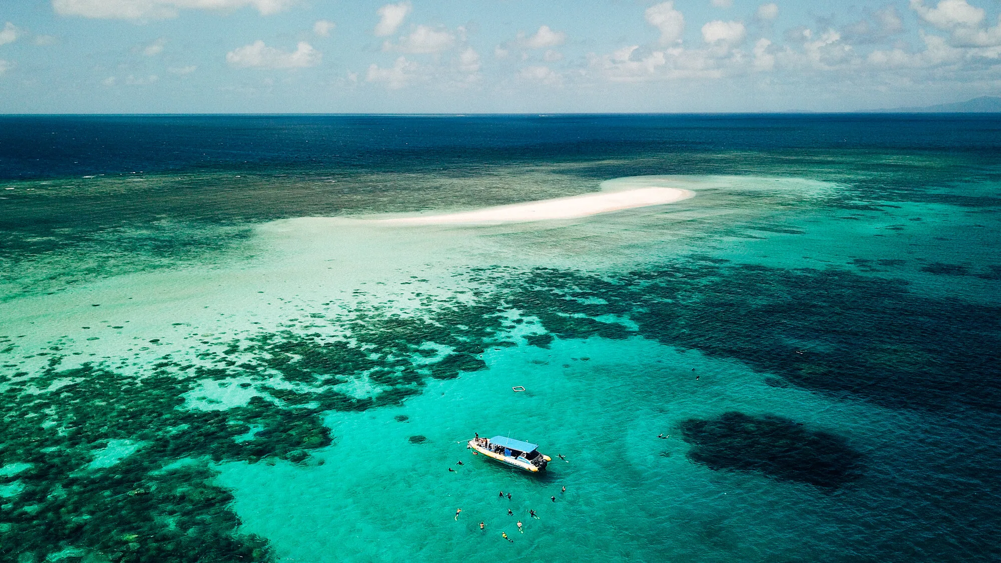 Great Barrier Reef sand cay and boat, aerial drone photo