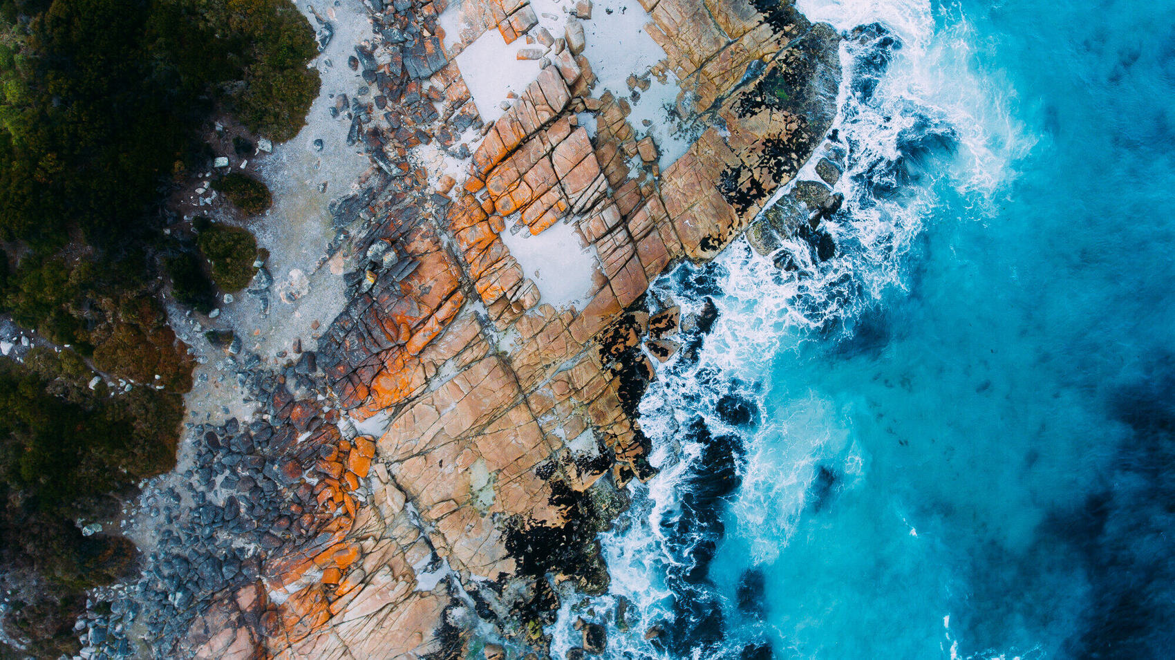 Bay of Fires orange lichen rocks and turquoise water, Tasmania aerial