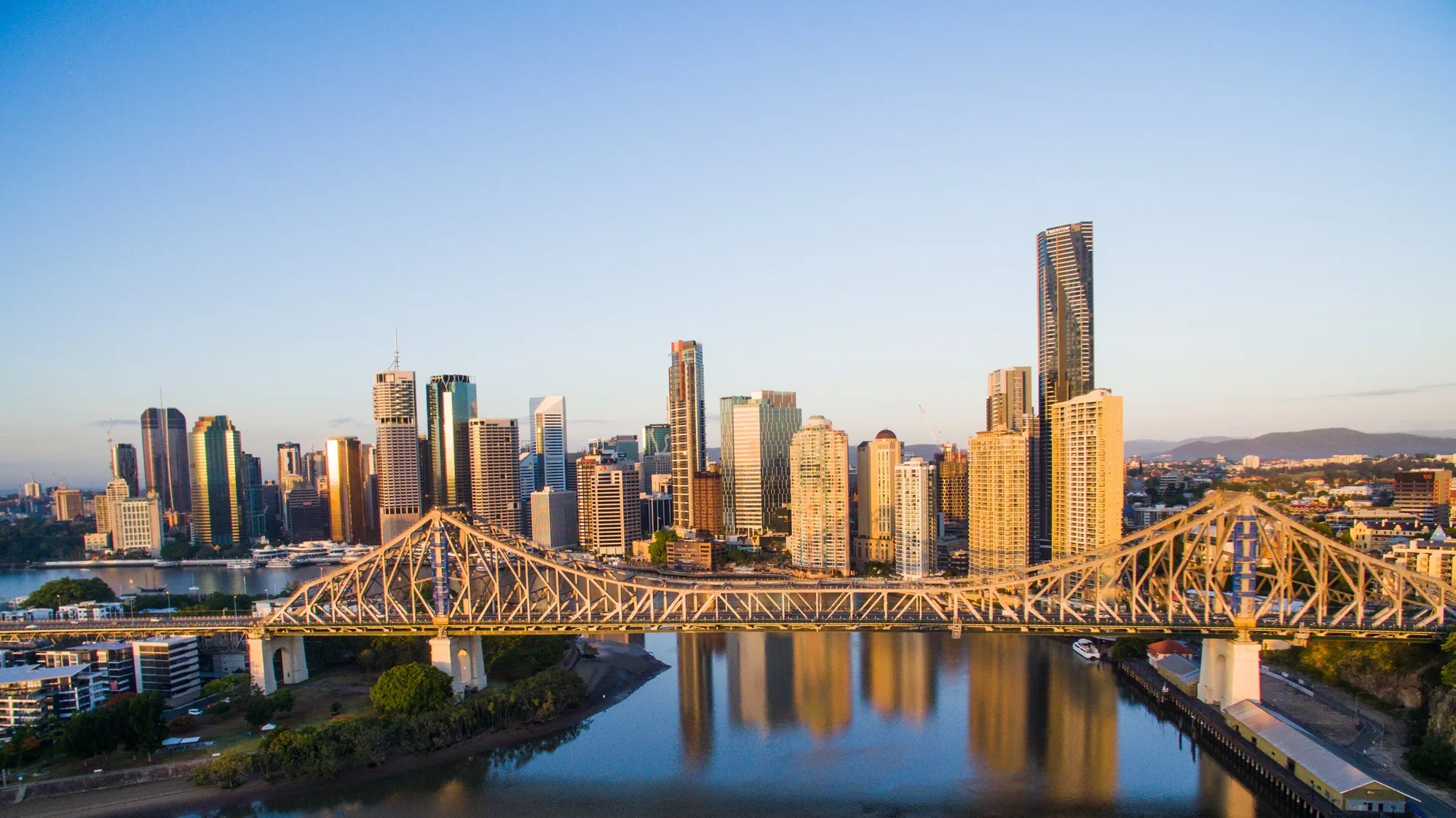 Brisbane skyline and Story Bridge at sunrise from the air