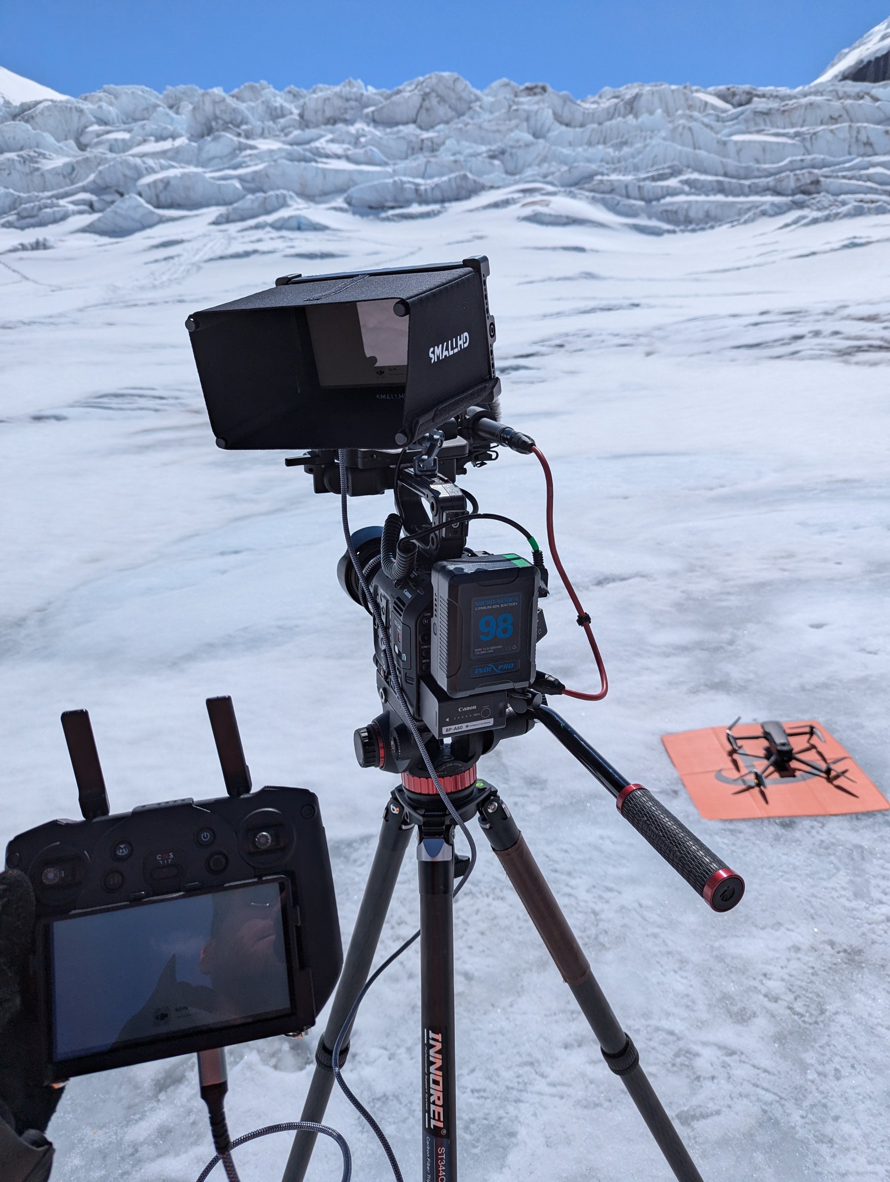 Canon C500 MKII with SmallHD monitor and DJI drone on landing pad — glacier production setup, Athabasca Glacier June 2024