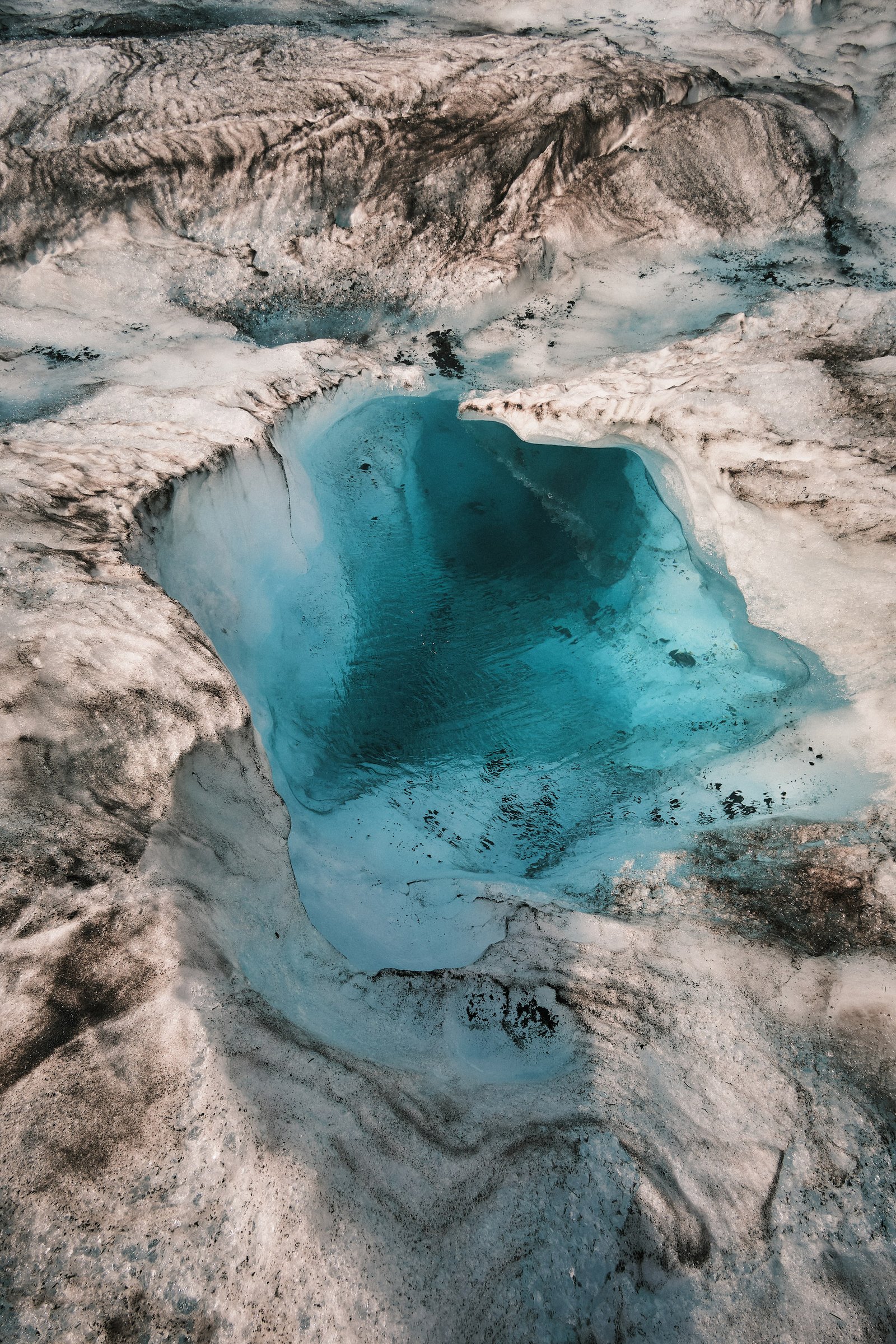Aerial view of turquoise glacial meltwater pool and moulin — DSCF0835, Athabasca Glacier June 2024