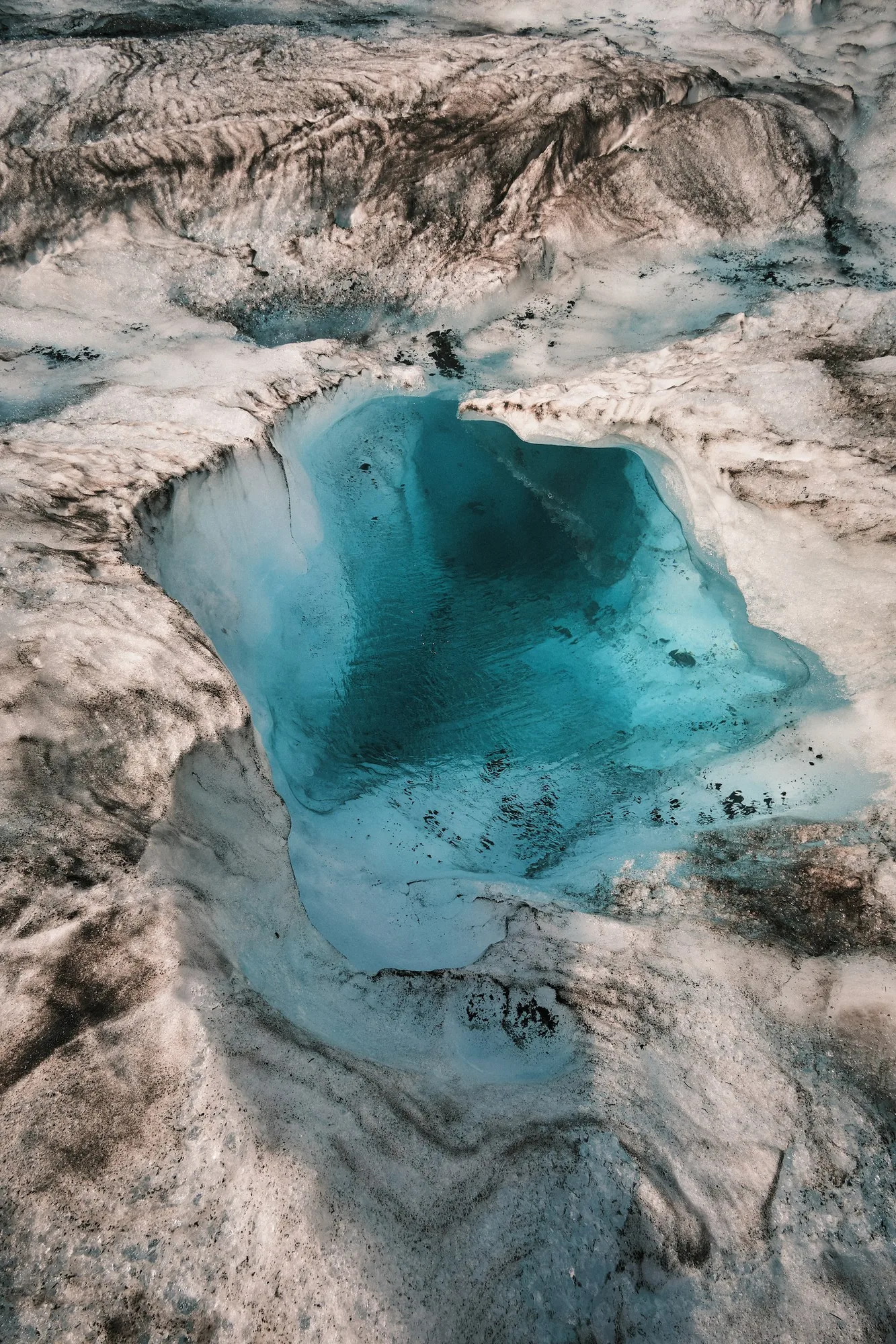 Aerial view of turquoise glacial meltwater pool and moulin — DSCF0835, Athabasca Glacier June 2024