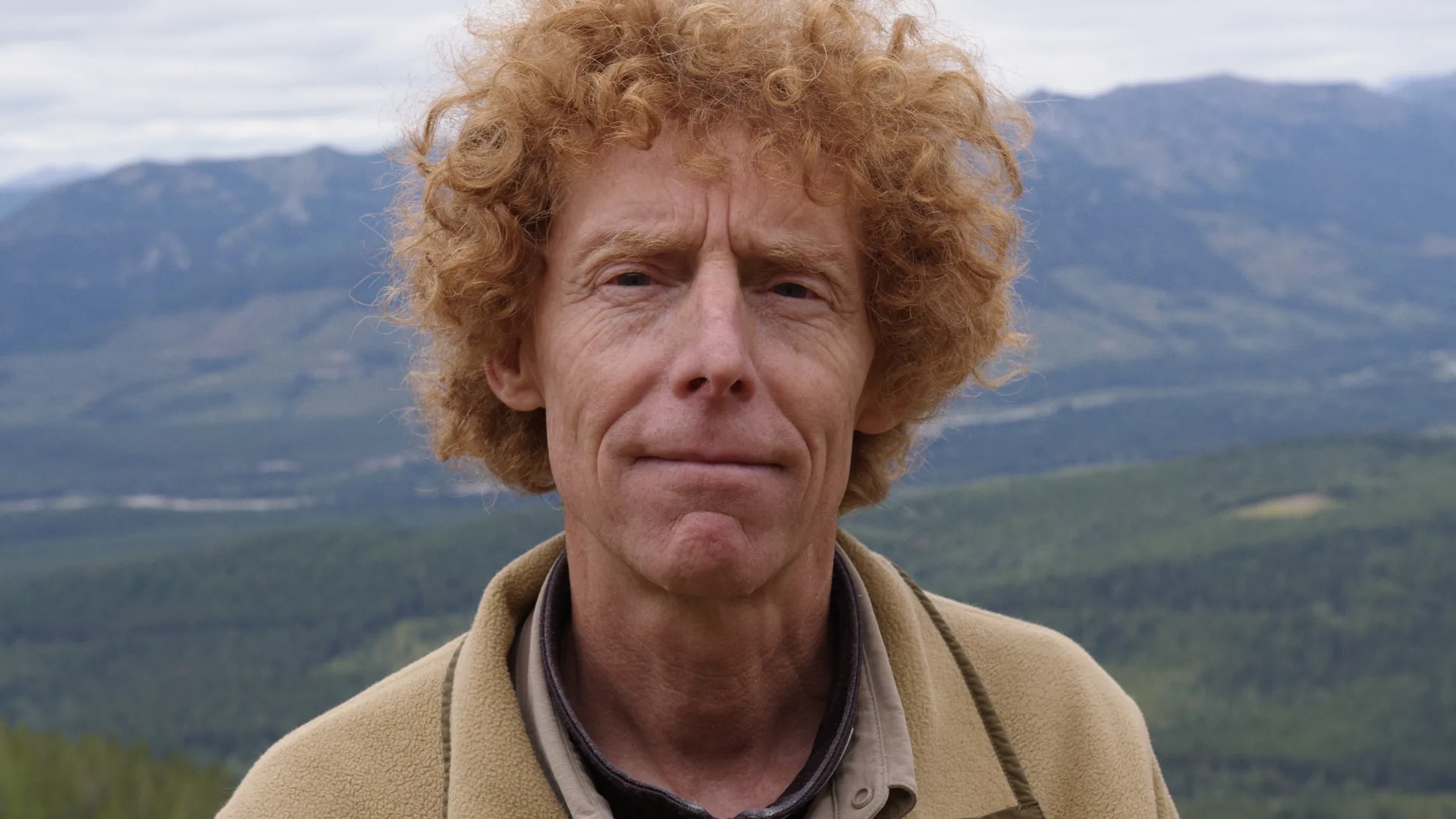 Close portrait of grizzly bear biologist Garth Mowat with the Flathead Valley behind him