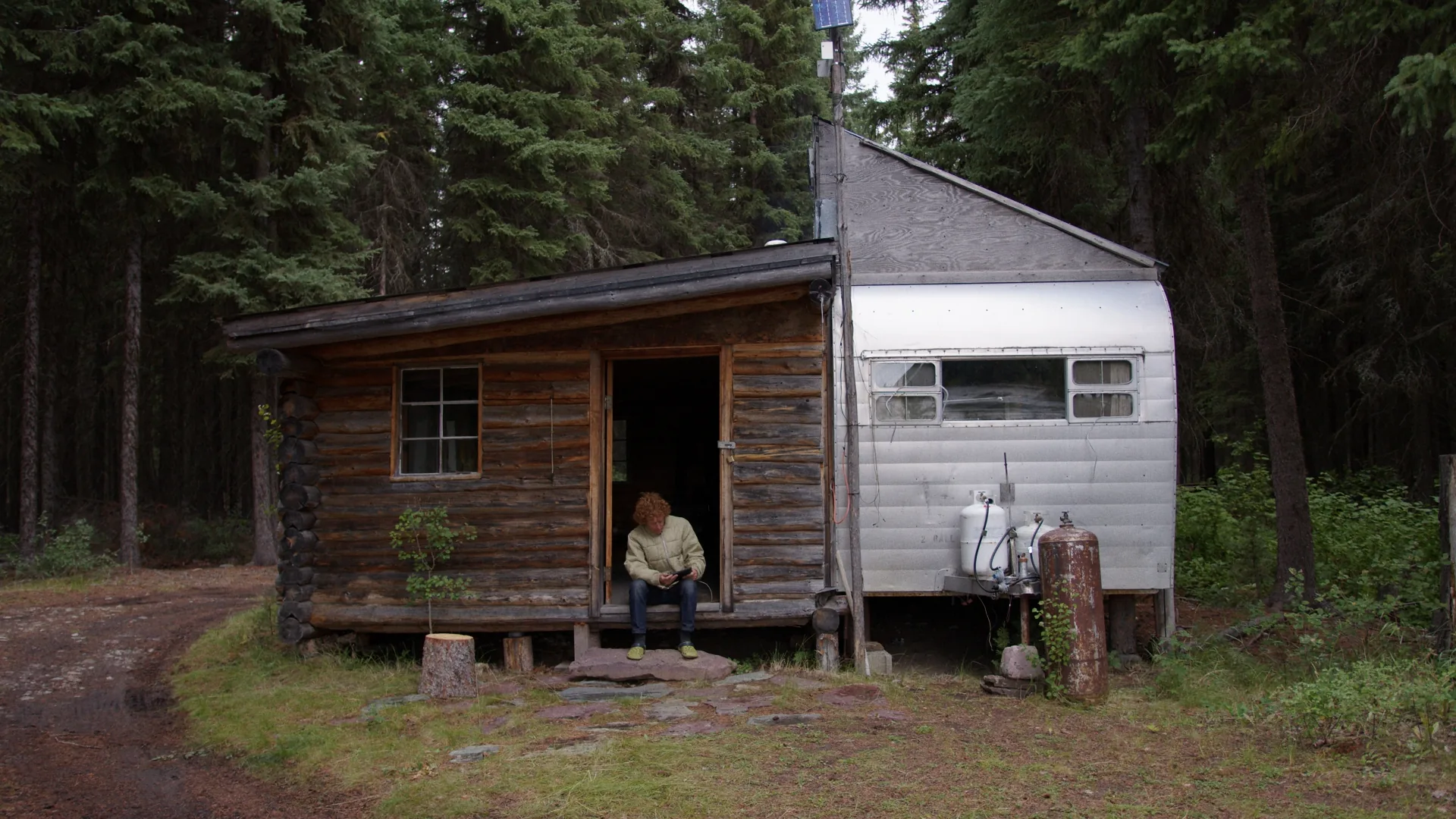 Log research cabin and trailer in the forest of the Flathead Valley