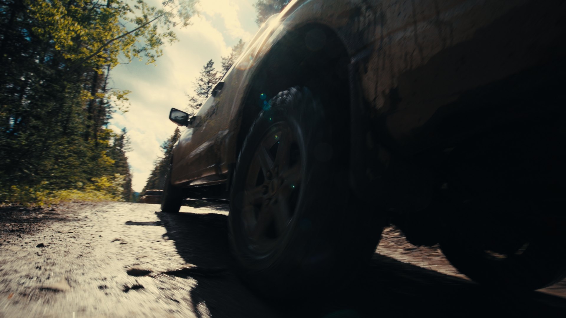 Low-angle tire POV in the mud — Hankook MT2 commercial frame