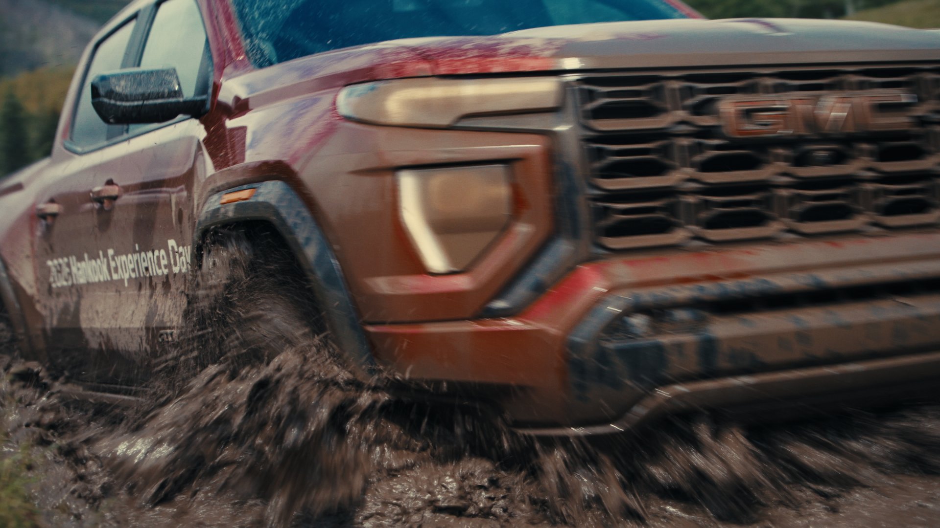 GMC Canyon splashing through mud — Hankook MT2 frame