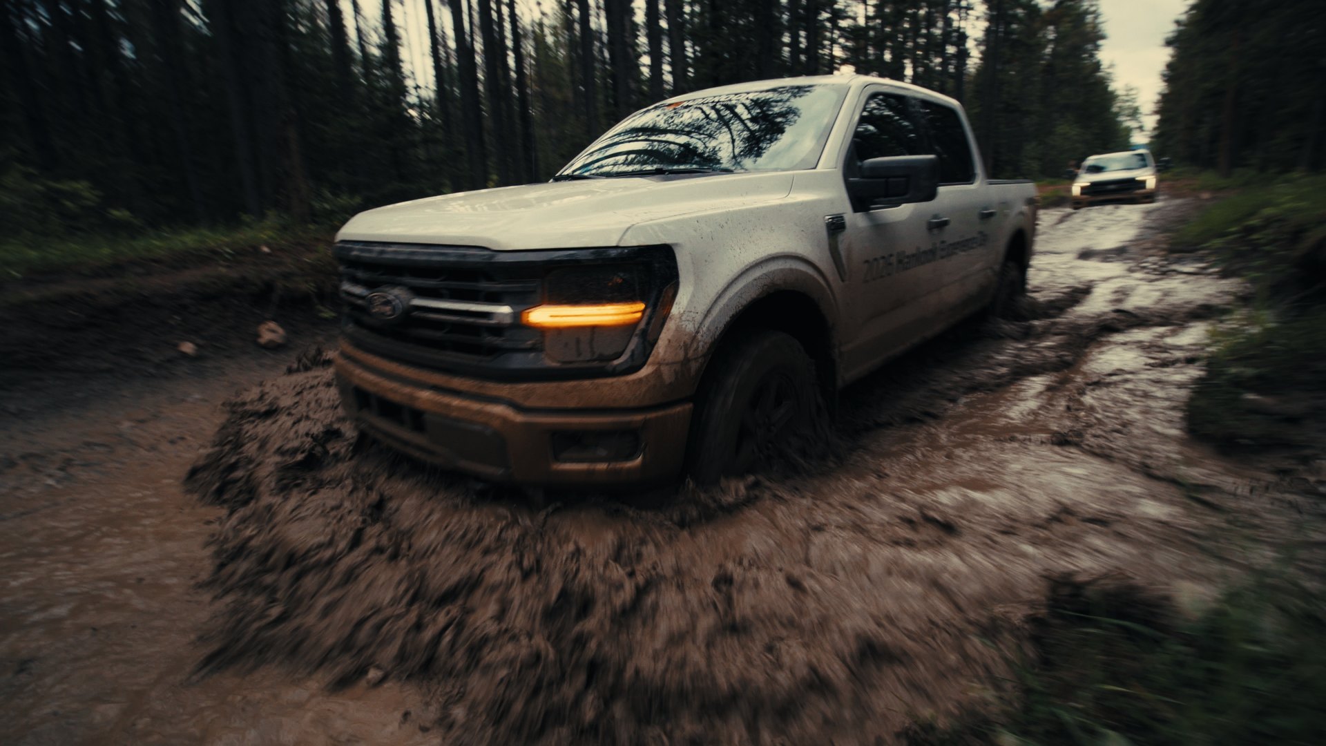 White F-150 on a muddy trail — Hankook MT2 frame
