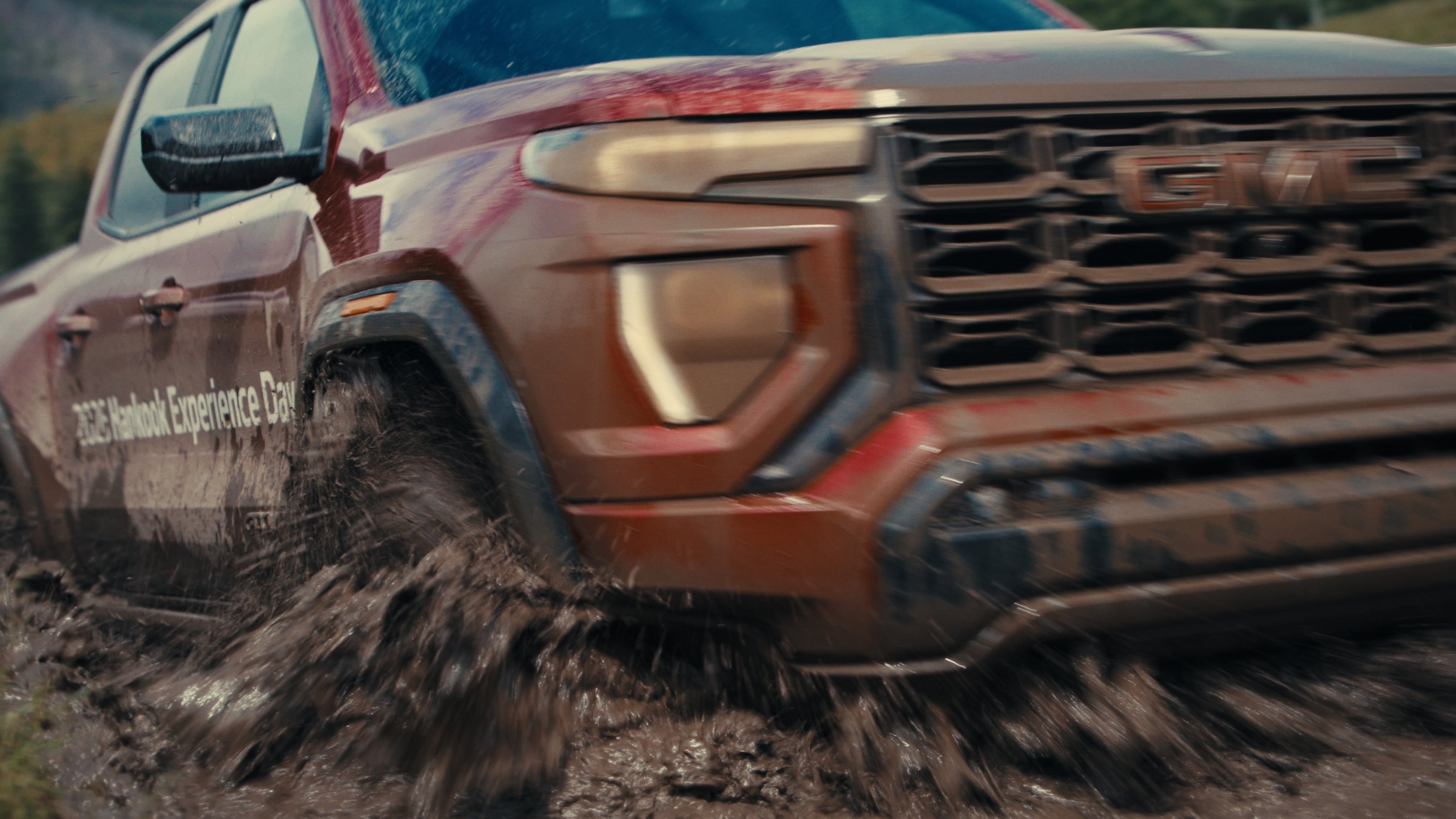 GMC Canyon throwing mud on a forest trail — Hankook MT2 tire commercial frame shot by DCFOTOFILM at McLean Creek, Alberta