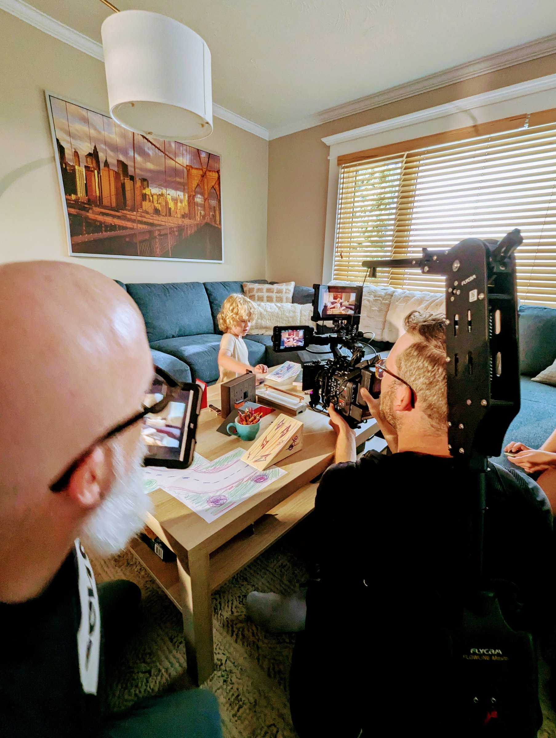 BTS — Doug Cook monitoring playback, Erik Johnson shooting on camera rig, Jasper on couch — Onewheel commercial, Calgary 2024