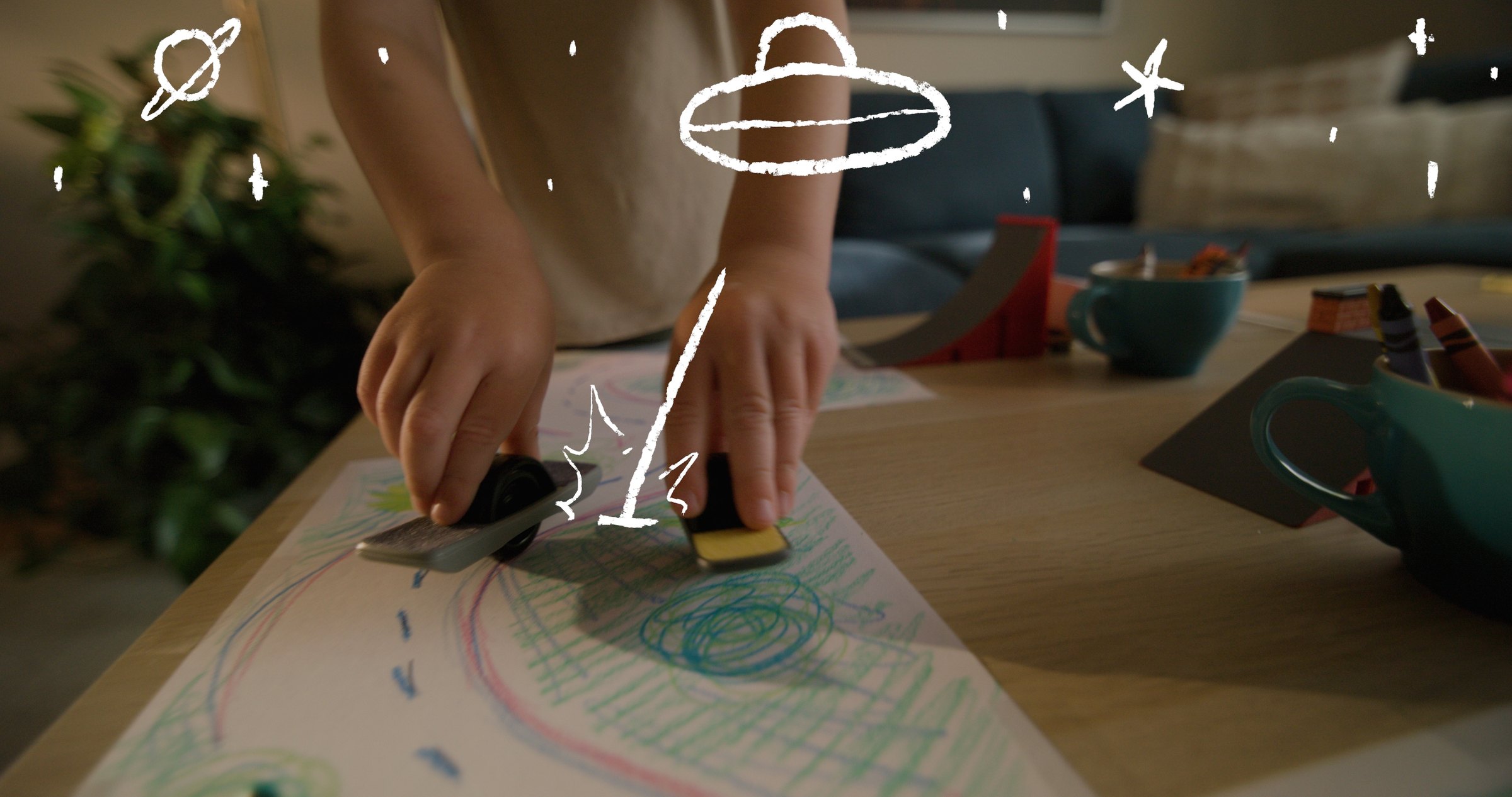 Onewheel commercial frame — Jasper's hands with tiny Onewheel, space doodles motion graphics overlay