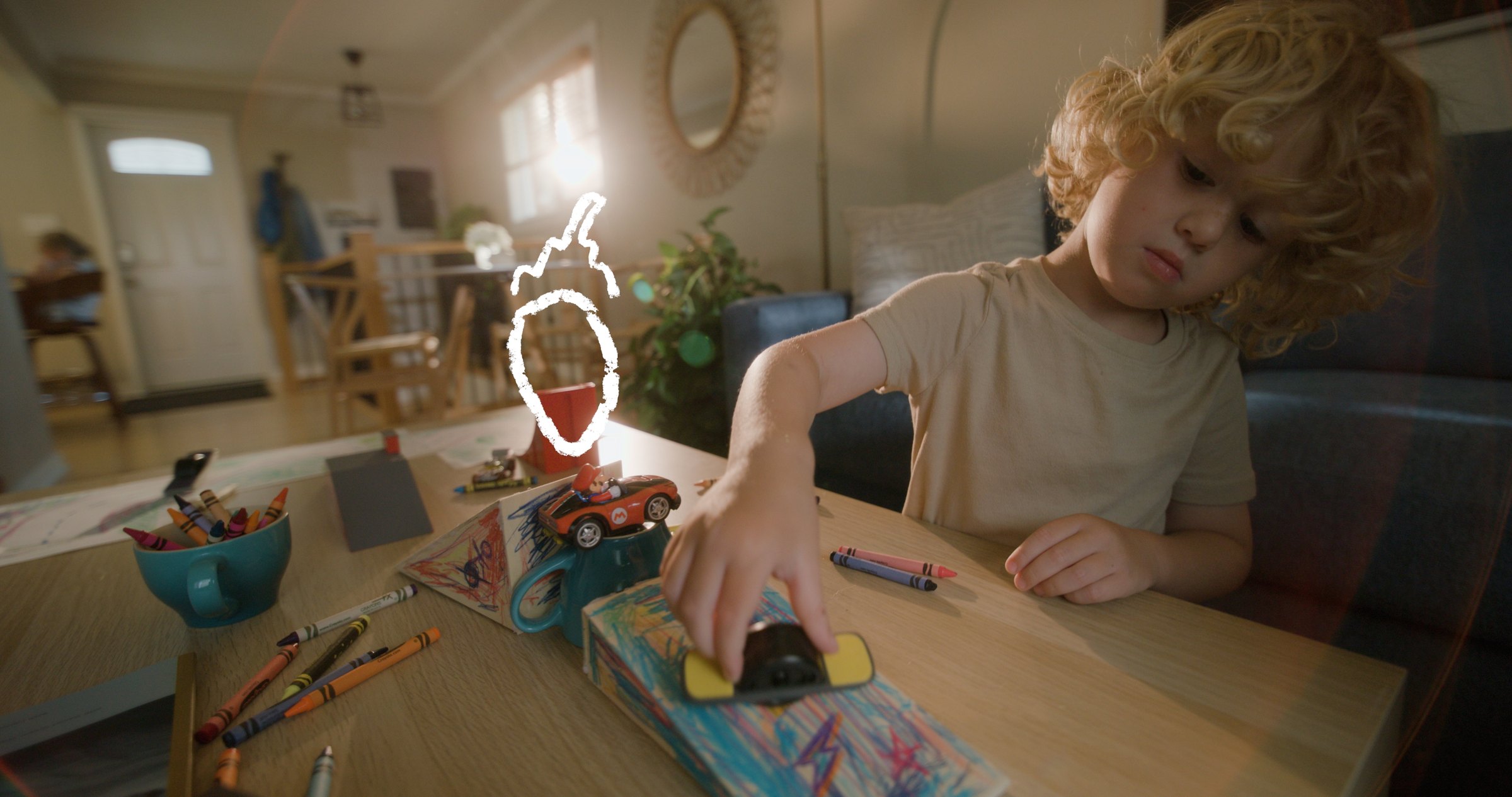 Onewheel commercial frame — drawing table close-up with Onewheel and crayons, motion graphics