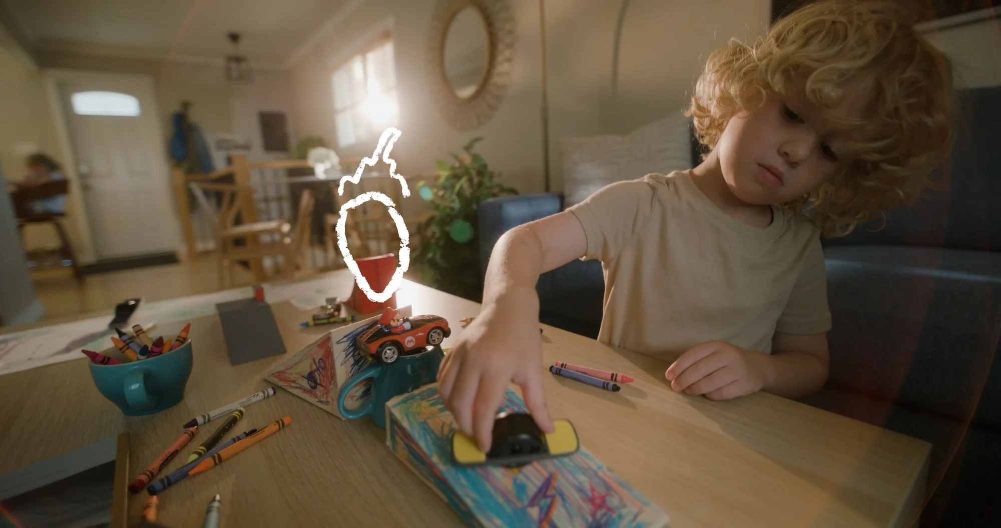 Onewheel commercial frame — drawing table close-up with Onewheel and crayons, motion graphics