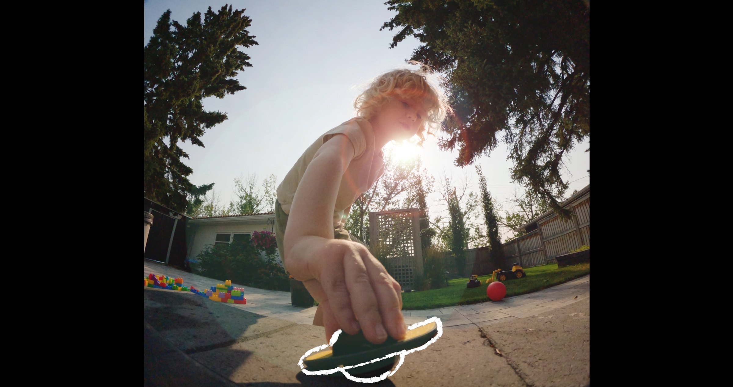 Onewheel commercial frame — fisheye snorricam, Jasper reaching toward Onewheel in backyard, sun flare