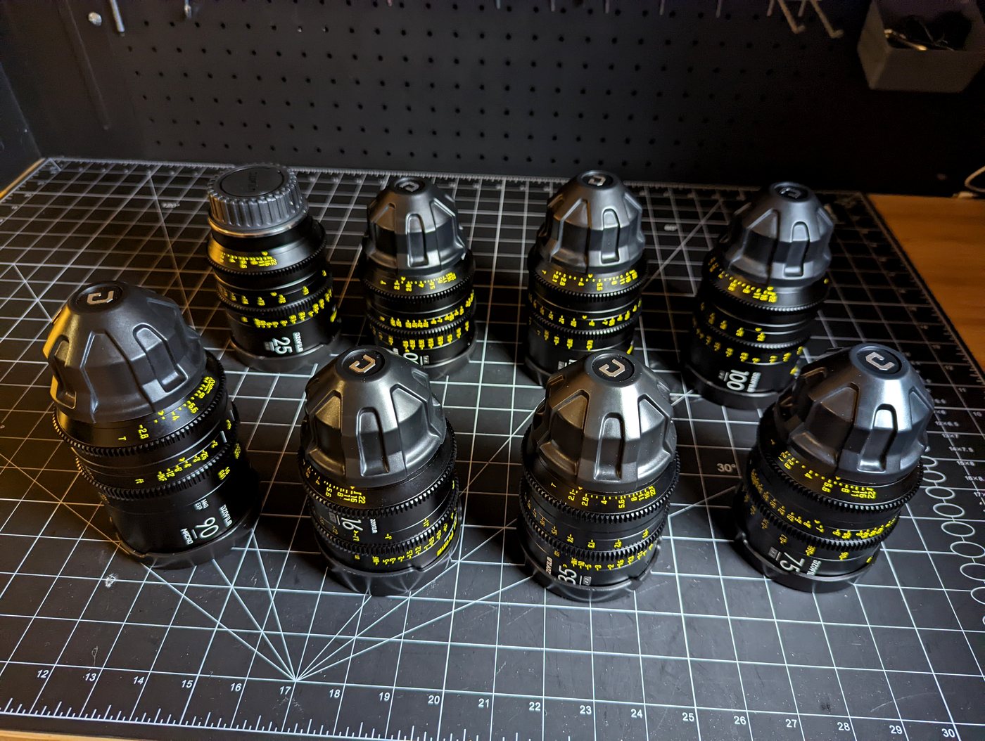 A set of professional cinema prime lenses laid out, part of a Calgary DP's camera package