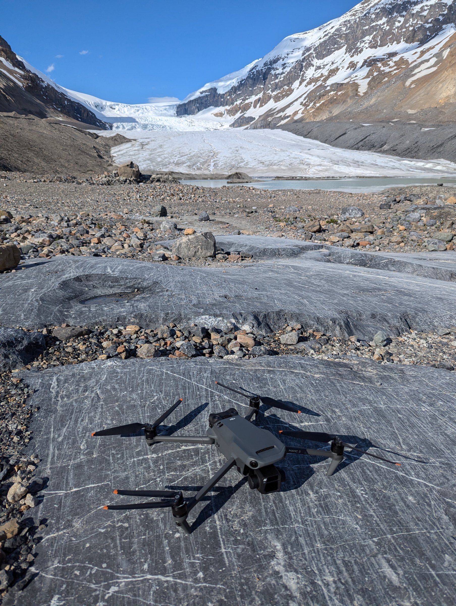 Cinema drone on a rock slab in front of the Athabasca Glacier — aerial cinematography by DCFOTOFILM