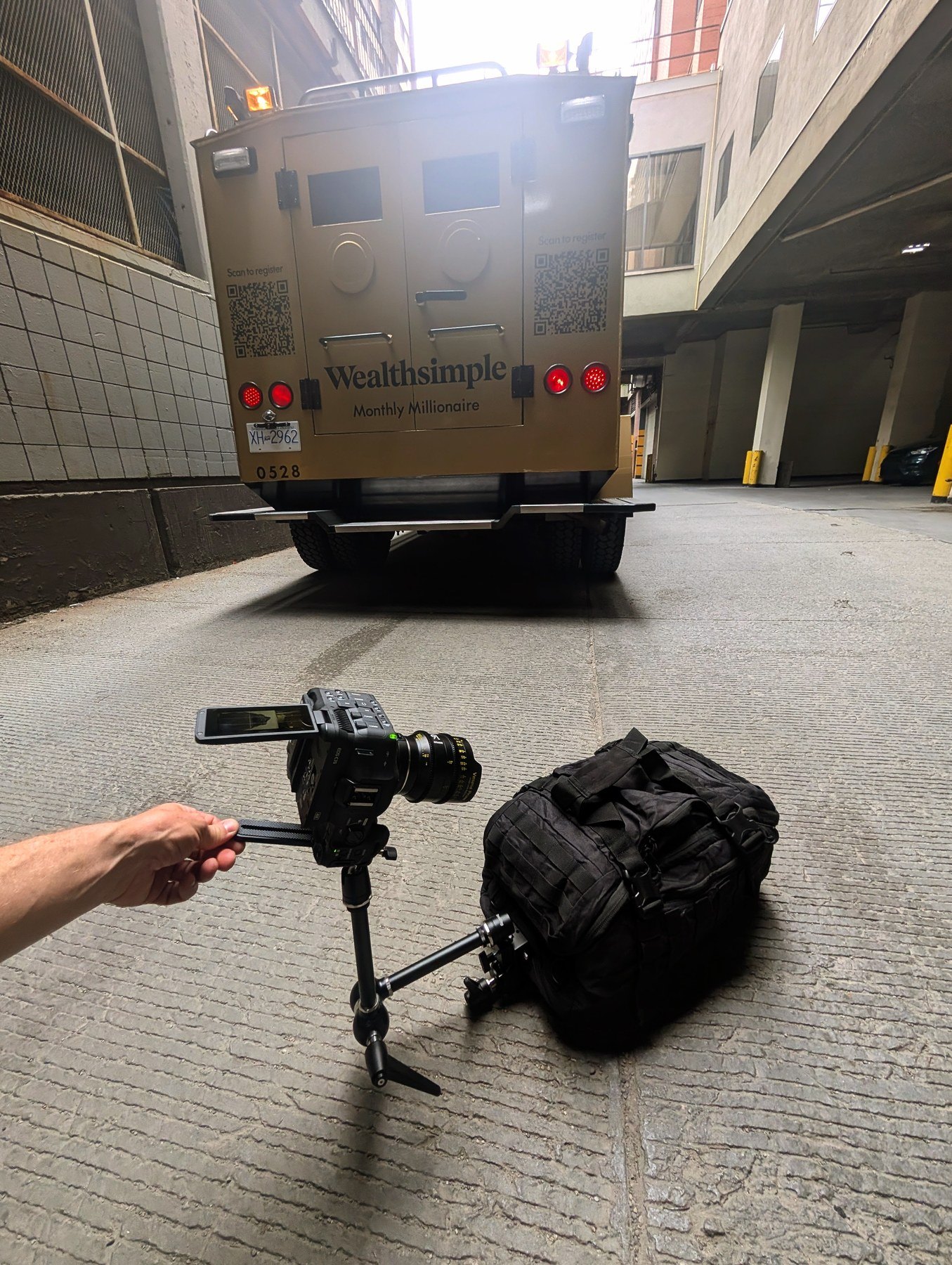 BTS of money bag POV shot — Canon C70 on monopod approaching Wealthsimple armored truck in downtown Calgary parking garage