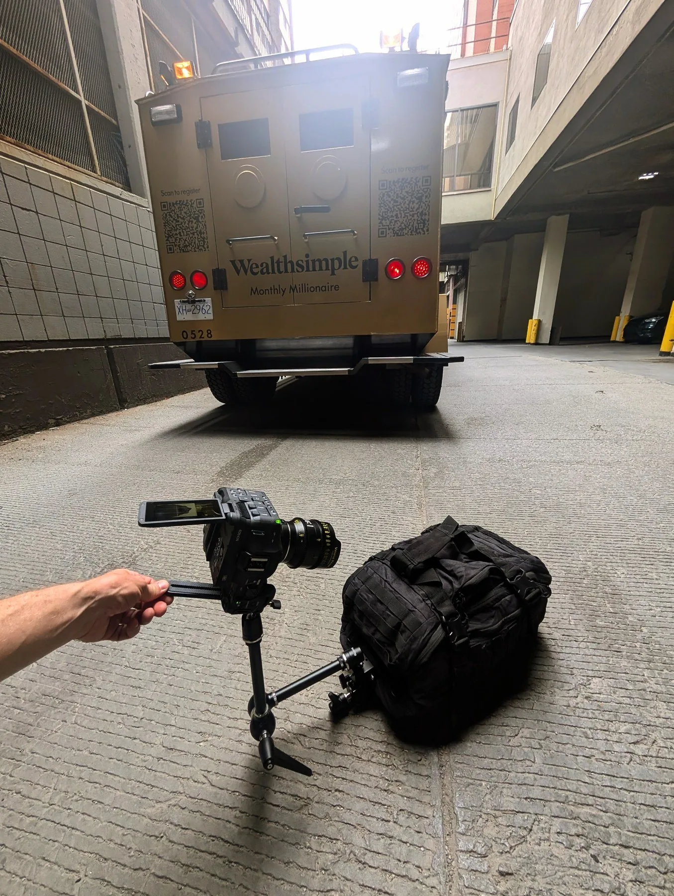 BTS of money bag POV shot — Canon C70 on monopod approaching Wealthsimple armored truck in downtown Calgary parking garage